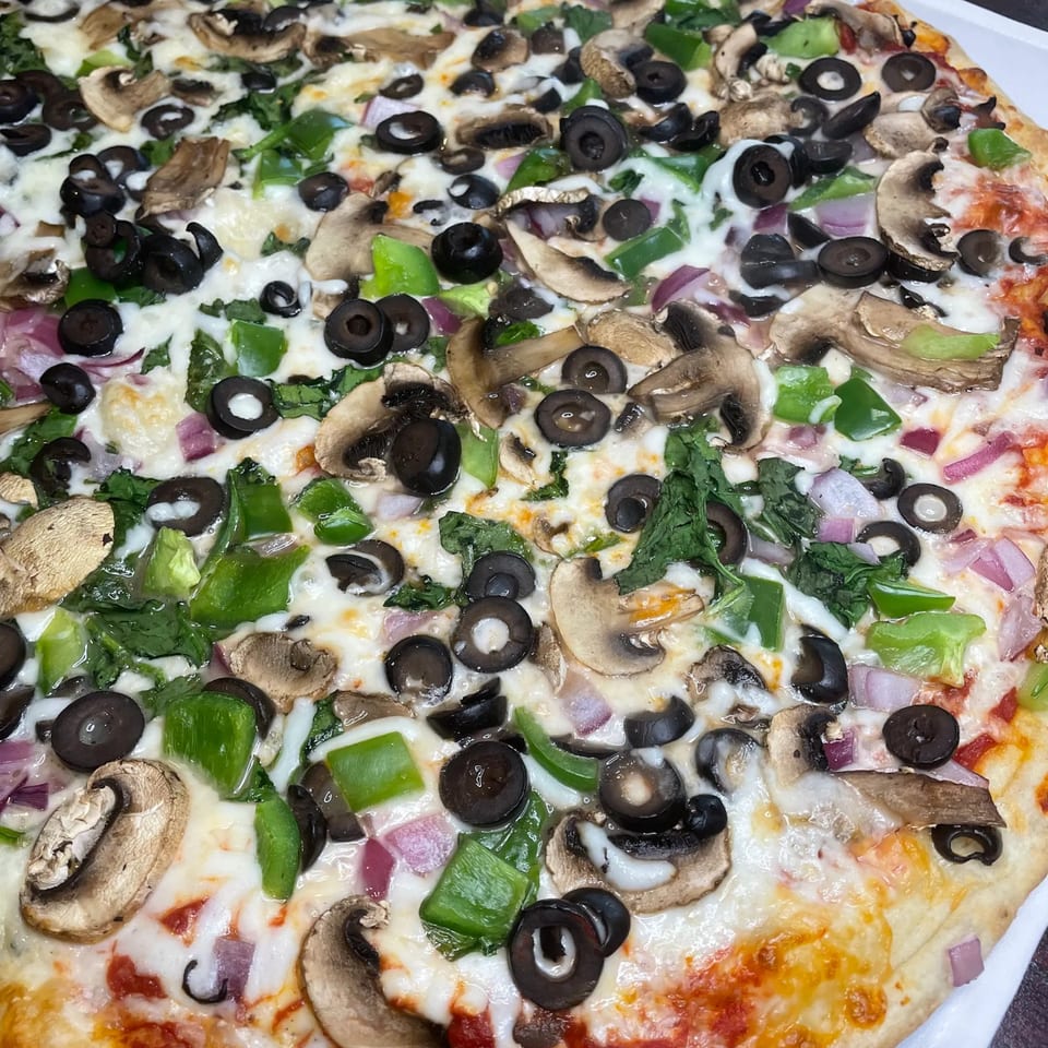 TopCrust Jupiter Kitchen's pizza with mushrooms, black olives, green peppers, and red onions.